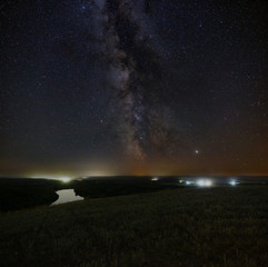 View of the Milky Way over the river. Bright stars of the night sky. Astrophotography with a long exposure.