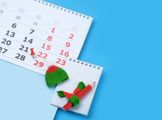 Calendar with marking in red pin of 29 february date. February month, calendar, notebook, pencil...