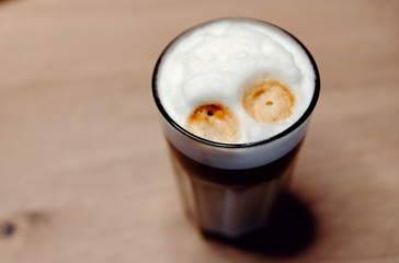 home coffee machine pours a mug of coffee,man's hand presses the start button of the coffee machine,hot coffee is poured into a glass,coffee at home