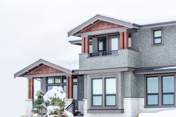 A typical american house in winter. Snow covered.