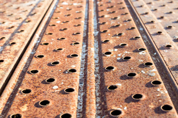 rusty yellow iron sheets with holes. selective focus