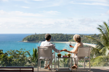 Senior Chinese couple relaxing on balcony