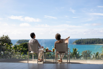 Senior Chinese couple relaxing on balcony