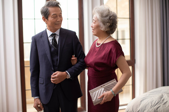 Loving senior Chinese couple at home