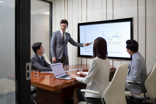 Chinese business people having meeting in conference room