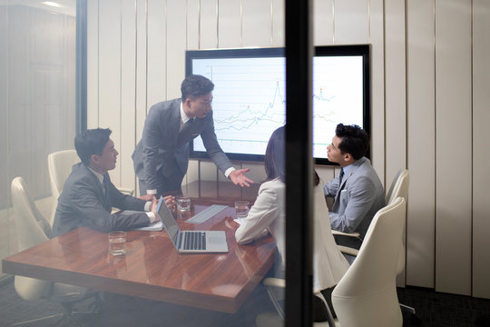 Chinese business people having meeting in conference room