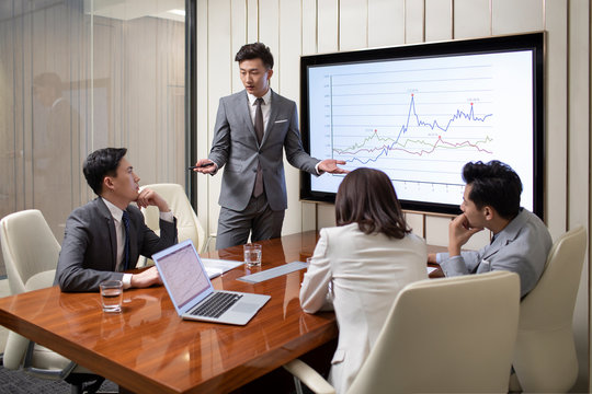 Chinese business people having meeting in conference room