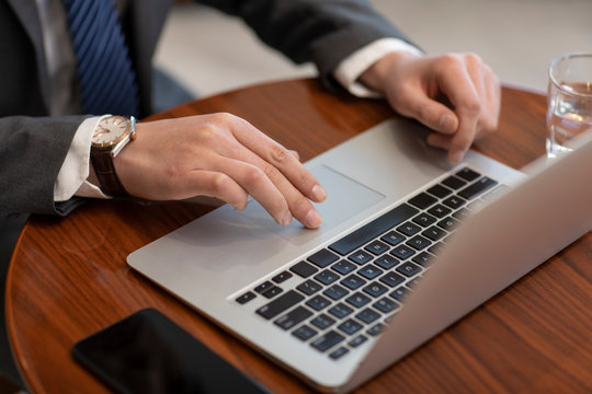 Confident Chinese businessman using laptop