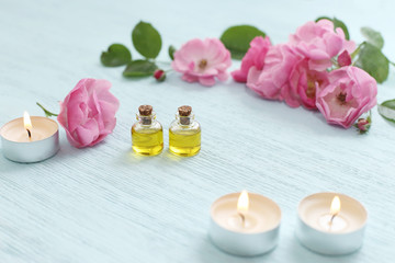 Plakat Rosehip cosmetic oil in mini bottles and pink rosehip flowers. Spa treatments for relaxation.