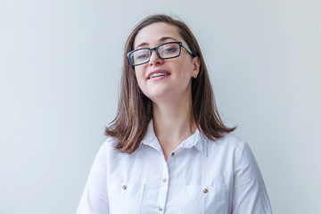 Beautiful happy girl smiling. Beauty simple portrait young smiling brunette woman in eyeglasses isolated on white background. Positive human emotion facial expression body language. Copy space