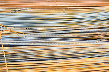 Iron metal rusty yellow bars of industrial building reinforcement from corrugated reinforcement for the construction of buildings made of reinforced concrete. Texture, background