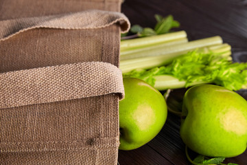 Reusable shopping jute bag with fresh fruits and greens on wooden background