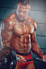 Fototapeta na wymiar Strong Muscular Bodybuilder Lifting Weights