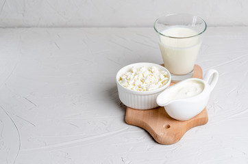 Homemade fermented products - kefir, cottage cheese, budget on a white background with copy space - obrazy, fototapety, plakaty