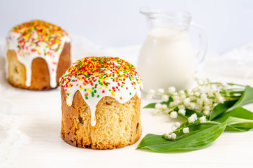 Easter cake decorated with white sugar icing and colored confectionery powder on a white background