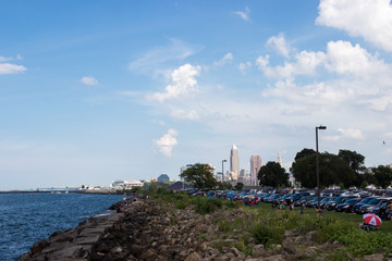 Lake Erie, Cleveland, Ohio/ USA - 3 September 2018: People relax on the beach, tall skyscrapers are visible in the distance. Cleveland skyline