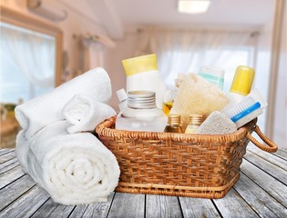 Fototapeta na wymiar Bath towel and basket with accessories for spa on desk