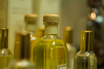 close up of bottle for perfume stand on the background of other bottles. Group of perfume glass bottles