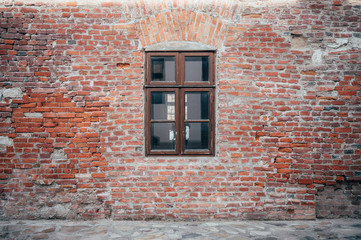 Old window in the middle of brick wall