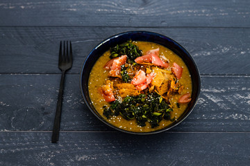 vegan vegetable stew with curry sauce kale tomatoes and torilla chips