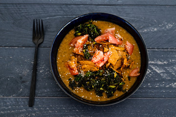 vegan vegetable stew with curry sauce kale tomatoes and torilla chips