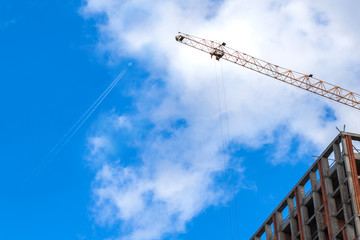 Fototapeta premium Construction of a modern residential complex. The construction of a multi-story building. cargo crane