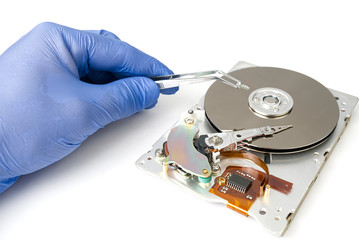 Obraz premium Hdd - hard disk drive. Hard disk repair concept. The hard drive is designed to store data of all mankind, so timely monitoring is very important. Pc industry. Disassembled hard disk on white