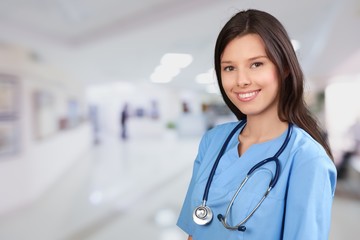 Beautiful young woman doctor smiling in work uniform