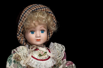 Porcelain doll,  isolated on black background