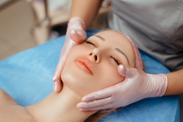 Fototapeta na wymiar face massage on woman in the spa salon