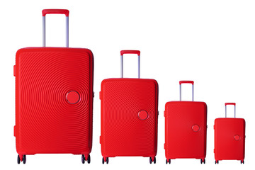 Four red hard case trolley bags isolated on white background. High end commercial product photography..Traveling, accesories and luggage concept.