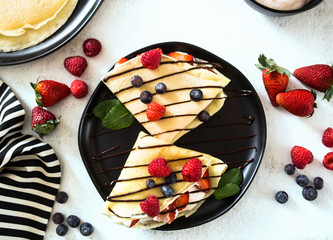 Crepes with cream filling and berries