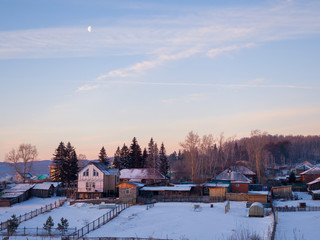 Fototapeta na wymiar Rural Russian landscape. Winter morning. Beautiful sky over the Siberian village