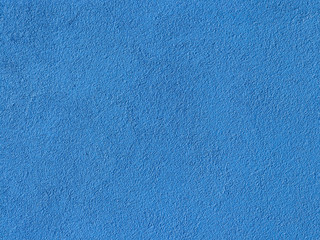 Seamless texture. The plastered wall is painted with blue paint. Rough surface