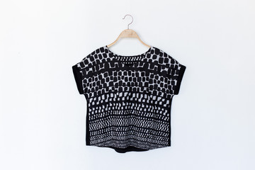 blouse is on clothes-hanger on white background.close up.