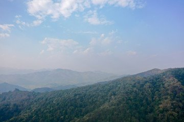 High angle scenic view of mountain against foggy sky 