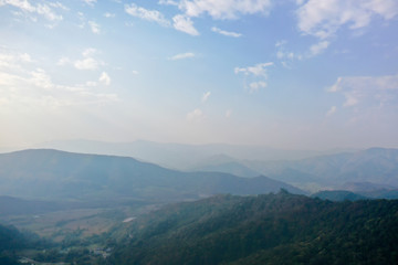 Naklejka premium High angle scenic view of mountain against foggy sky 