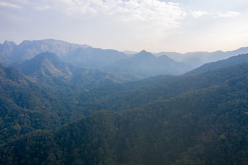 High angle scenic view of mountain against foggy sky 