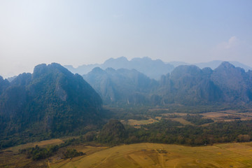Fototapeta premium Aerial view of Mountain against foggy sky