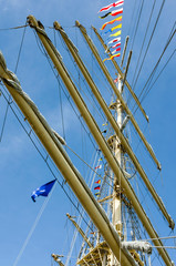 Mast sailing ship against a blue sky