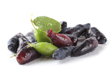 Honeyberry isolated on white. Ripe and unripe berries