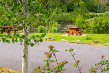 Picnic Table in Park with mountain lake background.
