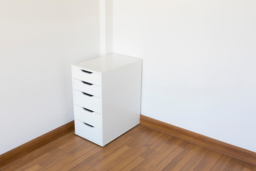 White modern cabinet on wood floor in white room