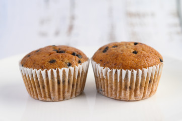 Banana cupcakes mixed with chocolate chip on a white plate.