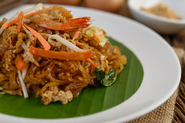 Padthai shrimp in a white dish.