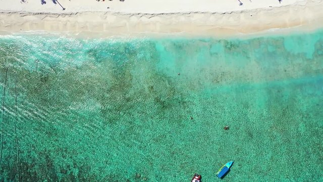 Luxury vacation concept. Boats moored in the crystal clear sea water near the tropical island. Gilli islands, Bali, Indonesia