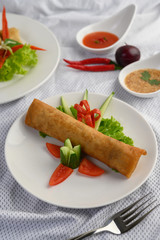 Egg roll or Fried Spring Rolls on the white plate Thai food. Selective focus.