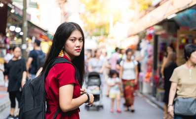 Asian woman tourists or blogger are touring and shopping in China Town shopping street during the Chinese New Year festival in travel at china town concept.