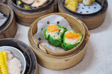 Steamed bamboo basket of hot manti shrimp dumplings , traditional Chinese food. Selective focus.