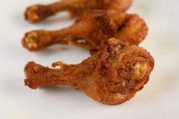 Fried chicken legs on a white plate